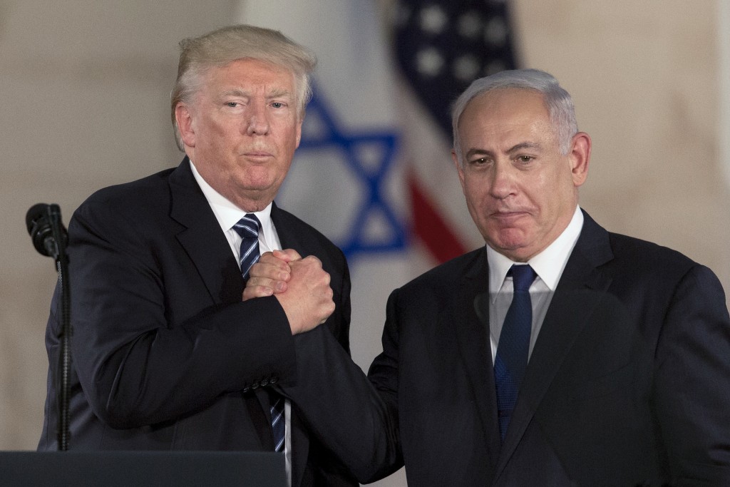 FILE - In this Tuesday, May 23, 2017 file photo, Israeli Prime Minister Benjamin Netanyahu, right, and US President Donald Trump shake hands at the Israel Museum in Jerusalem. (AP Photo/Sebastian Scheiner, File)