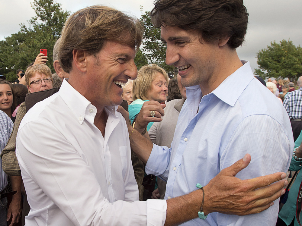 Liberal leader Justin Trudeau, right, chats with Stephen Bronfman, the party's chief fundraiser, at a barn party in St. Peters Bay, P.E.I. on Wednesday, Aug. 28, 2013. The Liberals are holding their summer caucus retreat in nearby Georgetown. THE CANADIAN PRESS/Andrew Vaughan