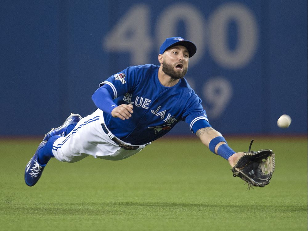 TORONTO, ONTARIO: OCTOBER 14, 2015--PLAYOFFS--Toronto Blue Jay Kevin Pillar makes a diving catch in the fourth inning agsint Texas Rangers player Elvis Andrus in game five of the ALDS MLB playoff series at Toronto's Rogers Centre, Wednesday October 14, 2015.  (Tyler Anderson/National Post) [For Sports story by John Lott, Eric Koreen and Scott Stinson/Sports]  //NATIONAL POST STAFF PHOTO ORG XMIT: POS1510141654520755