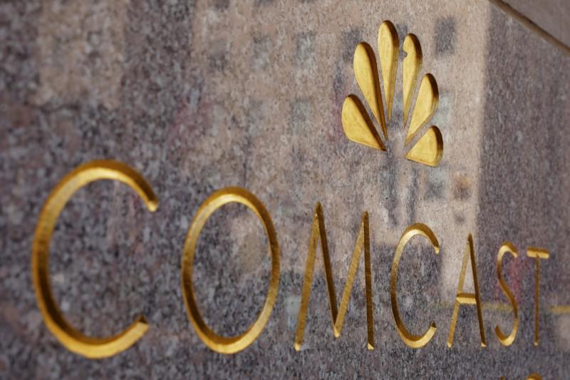 FILE PHOTO: The NBC and Comcast logos are displayed on 30 Rockefeller Plaza in midtown Manhattan in New York, U.S., February 27, 2018.  REUTERS/Lucas Jackson